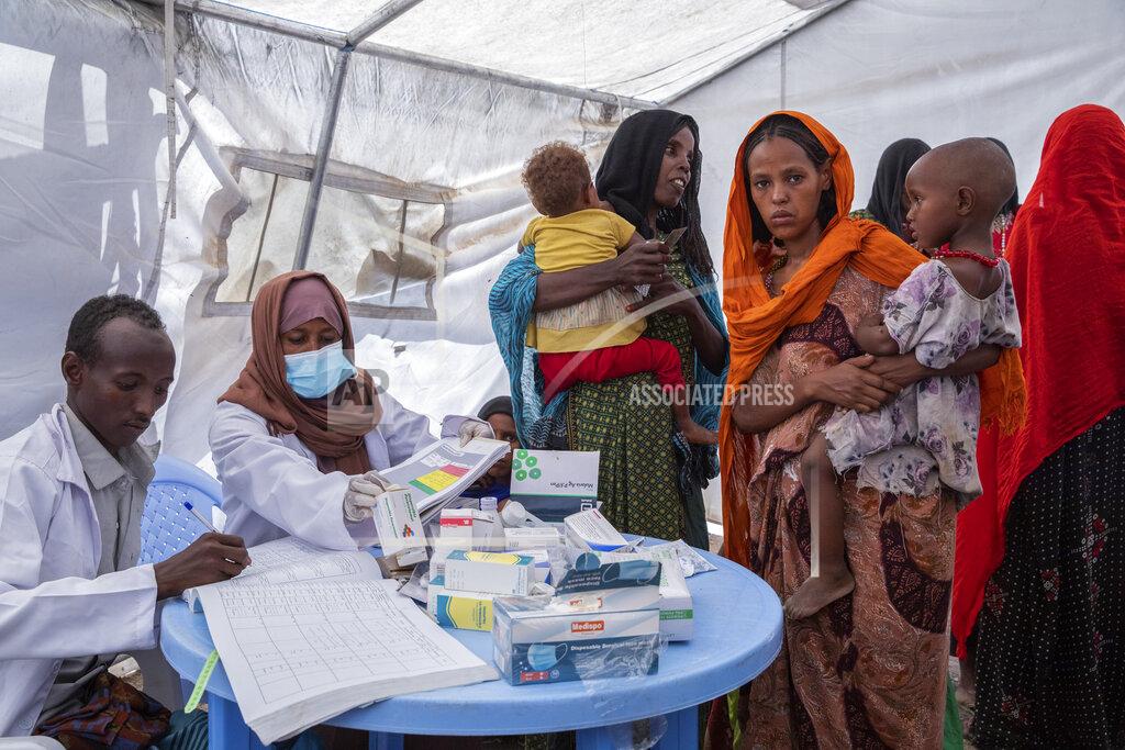 Zerihun Sewunet In this photo released by UNICEF, a mobile health and nutrition team attends to displaced mothers and their children at the Guyah site for internally-displaced people in the Afar region of Ethiopia Tuesday, May 10, 2022.. According to UNICEF, the Afar region is facing multiple humanitarian emergencies and mass displacement due to drought and conflict, which has resulted in devastating food insecurity. (Zerihun Sewunet/UNICEF via AP)