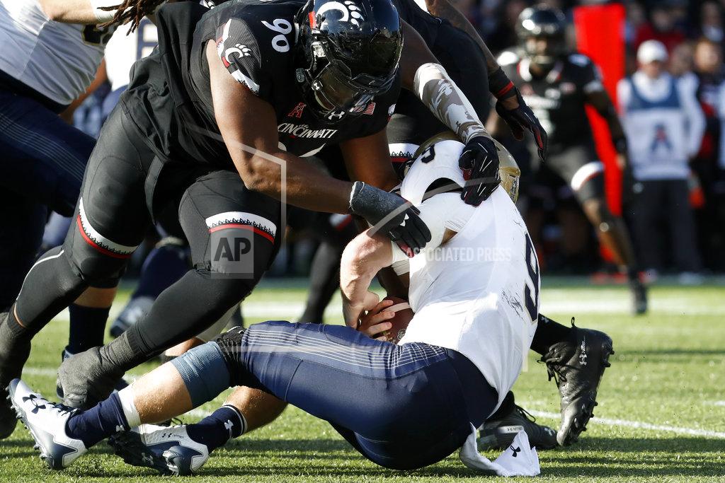John Minchillo Navy wide receiver Zach Abey (9) is sacked by Cincinnati defensive tackle Cortez Broughton (96) in the first half of an NCAA college football game, Saturday, Nov. 3, 2018, in Cincinnati. (AP Photo/John Minchillo)