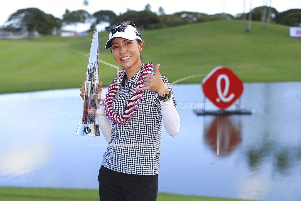 Marco Garcia Lydia Ko, of New Zealand, holds the Lotte Championship trophy after winning the golf tournament, Saturday, April 17, 2021, in Kapolei, Hawaii. (AP Photo/Marco Garcia)