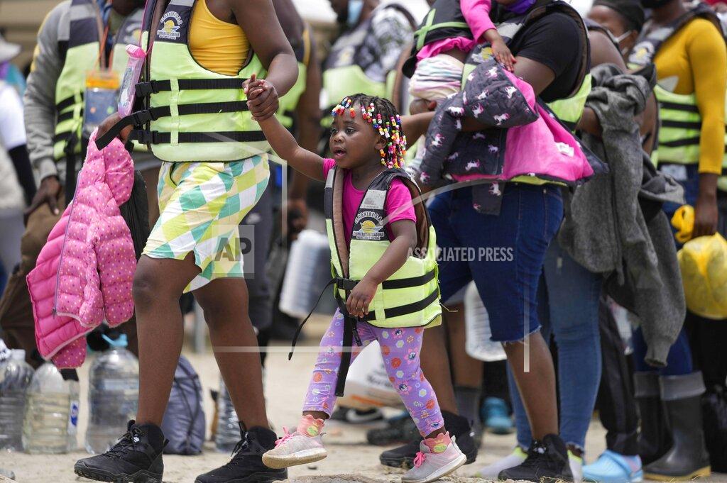Fernando Vergara Haitian migrants prepare to board boats in Necocli, Colombia, Monday, Sept. 13, 2021. Migrants have been gathering in Necocli as they move north to Acandi, near Colombia's border with Panama, on their journey to the U.S. border (AP Photo/Fernando Vergara)