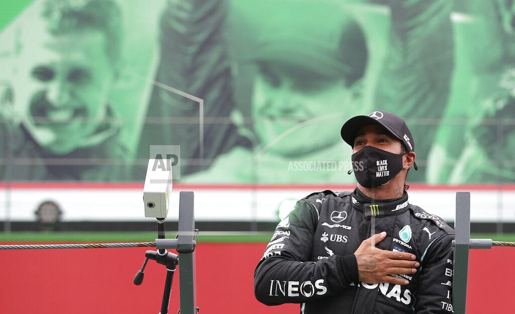 Jose Sena Goulao Mercedes driver Lewis Hamilton of Britain after his record breaking 92nd win at the Formula One Portuguese Grand Prix at the Algarve International Circuit in Portimao, Portugal, Sunday, Oct. 25, 2020. (Jose Sena Goulao, Pool via AP)
