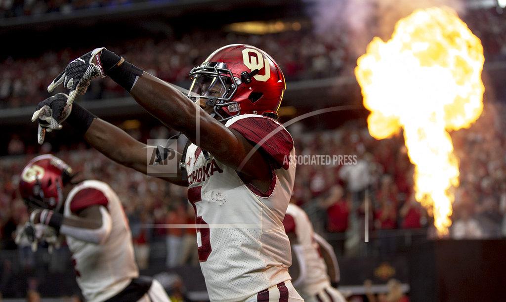 Nick Wagner Oklahoma wide receiver Marquise Brown (5) flashes the Horns down as he takes the field before the Big 12 Conference championship NCAA college football game against Texas in Arlington, Texas, on Saturday, Dec. 1, 2018. (Nick Wagner/Austin American-Statesman via AP)