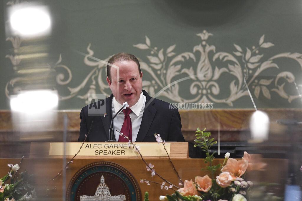 Gov. Jared Polis delivers his state of the state address in front of the House of Representatives at the Colorado State Capitol Building in Denver on Wednesday, Feb. 17, 2021. (AAron Ontiveroz/The Denver Post via AP, Pool)