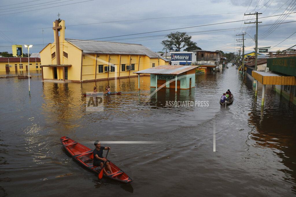 Edmar Barros Residents navigate flooded streets in Anama, Amazonas state, Brazil, Thursday, May 13, 2021. (AP Photo/Edmar Barros)
