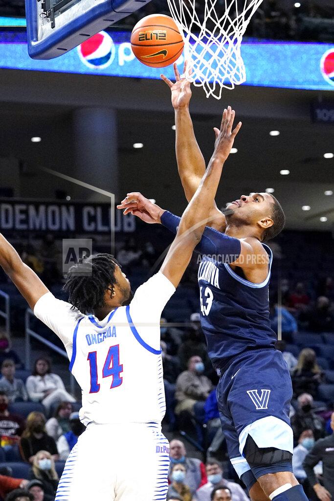 Nam Y. Huh Villanova forward Eric Dixon, right, shoots over DePaul center Nick Ongenda during the first half of an NCAA college basketball game in Chicago, Saturday, Jan. 8, 2022. (AP Photo/Nam Y. Huh)