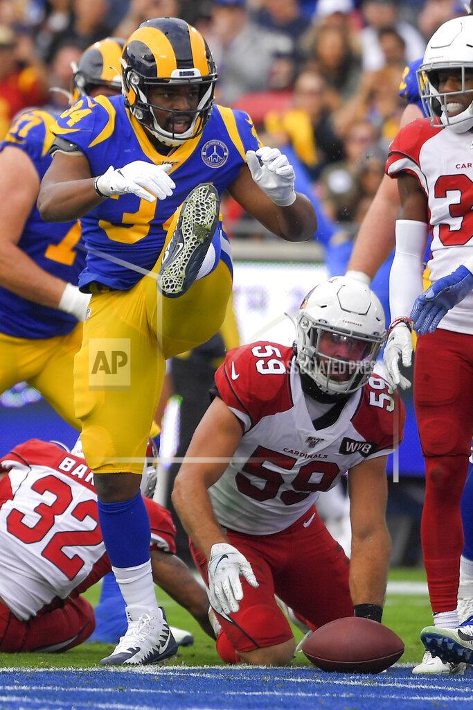 Mark J. Terrill Los Angeles Rams running back Malcolm Brown celebrates after scoring as Arizona Cardinals linebacker Joe Walker looks on during first half of an NFL football game Sunday, Dec. 29, 2019, in Los Angeles. (AP Photo/Mark J. Terrill)