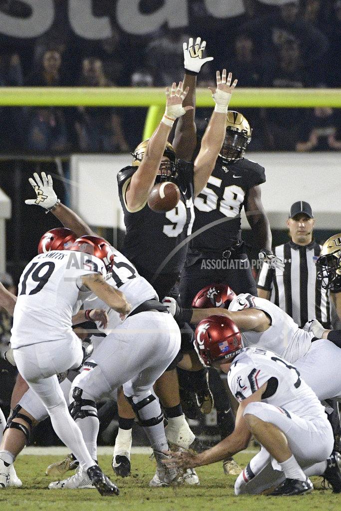 Phelan M. Ebenhack Central Florida defensive lineman Joey Connors (91) tries to block a 41-yard field goal attempt by Cincinnati place kicker Cole Smith (19) during the first half of an NCAA college football game Saturday, Nov. 17, 2018, in Orlando, Fla. (AP Photo/Phelan M. Ebenhack)