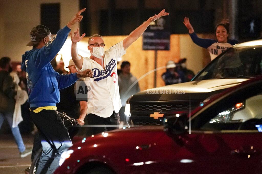 Baseball fans celebrate in downtown after the Los Angeles Dodgers won the World Series over the Tampa Bay Rays, Tuesday, Oct. 27, 2020, in Los Angeles. (AP Photo/Ashley Landis)