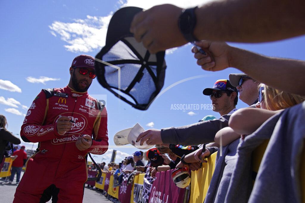 John Locher Driver Bubba Wallace (23) signs autographs before a NASCAR Cup Series auto race Sunday, March 6, 2022, in Las Vegas. (AP Photo/John Locher)