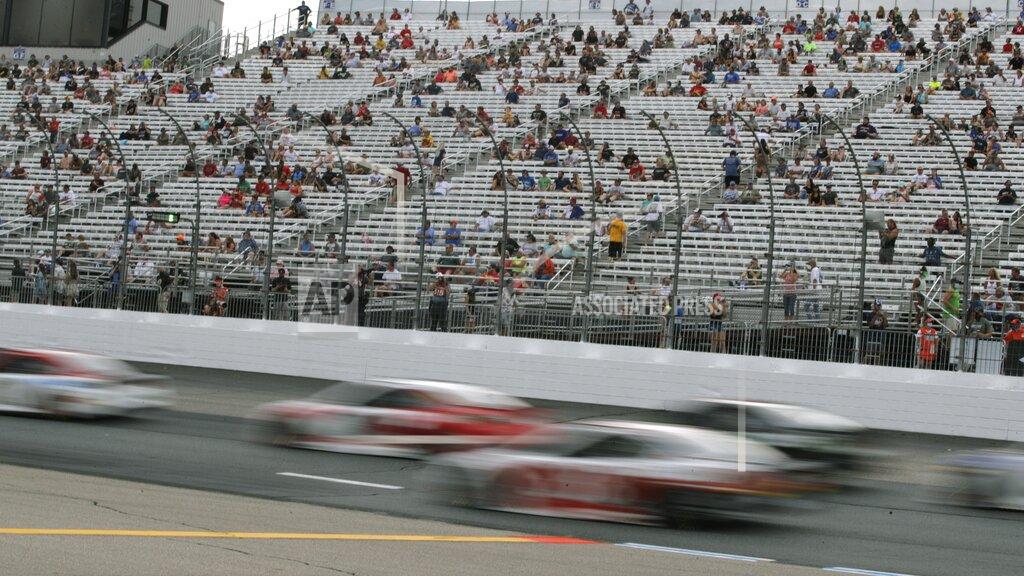 Charles Krupa Cars streak past fans, sitting socially distanced, due to the coronavirus pandemic, in the grandstand during a NASCAR Cup Series auto race, Sunday, Aug. 2, 2020, at the New Hampshire Motor Speedway in Loudon, N.H. (AP Photo/Charles Krupa)