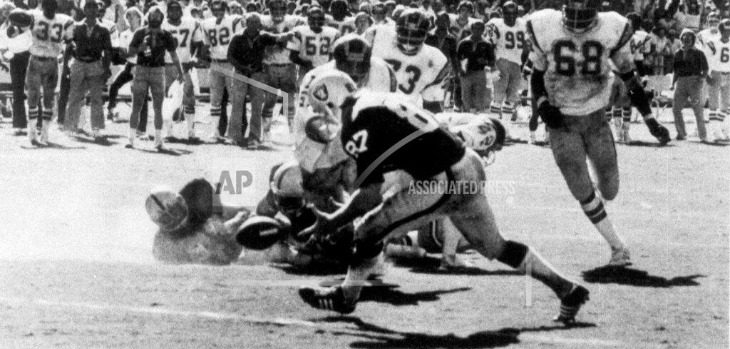 Thane Mcintosh FILE - In this Sept. 11, 1978, file photo, on the final play of the game between the Oakland Raiders and the San Diego Chargers, Raiders' Dave Casper (87) scoops up the ball fumbled by Raider's quarterback Ken Stabler on the five-yard line, in San Diego. Stabler dropped back to pass and was pressured by Chargers linebacker Woodrow Lowe. With nowhere to throw the ball, Stabler either fumbled or pushed the ball forward on purpose, depending on which side of the rivalry is telling the story. Teammate Pete Banaszak then knocked the ball further ahead from about the 13-yard line as it rolled toward the end zone. Tight end Dave Casper kicked the ball forward at the 5 and then fell on it in the end zone with no time remaining. (Thane McIntosh/The San Diego Union-Tribune via AP, File)