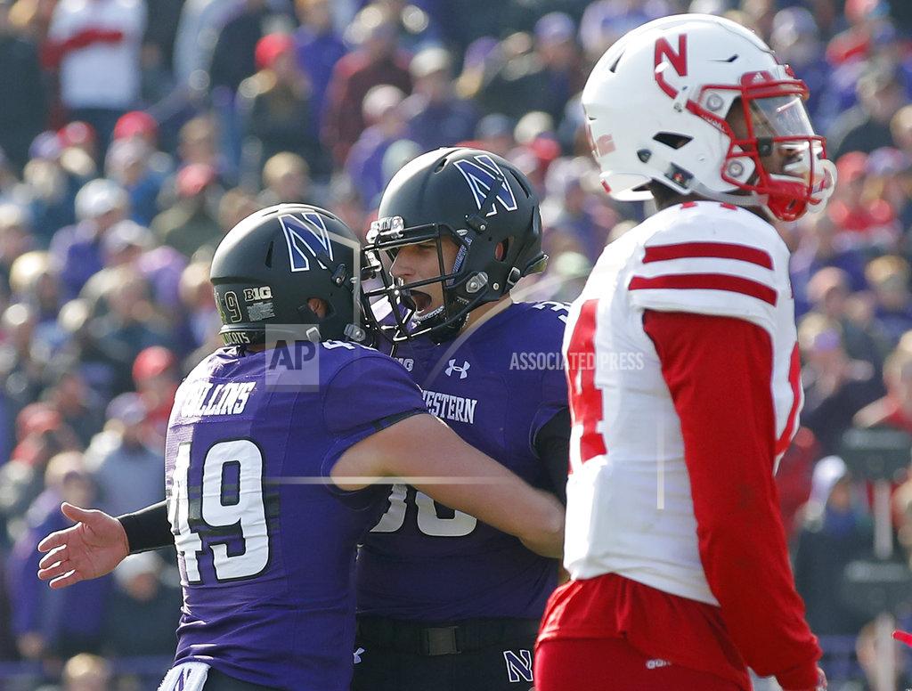 Jim Young Northwestern's Drew Luckenbaugh, center, celebrates his game-winning field goal in overtime with teammate Jake Collins, left, next to Nebraska's Tre Neal in an NCAA college football game Saturday, Oct. 13, 2018, in Evanston, Ill.. (AP Photo/Jim Young)