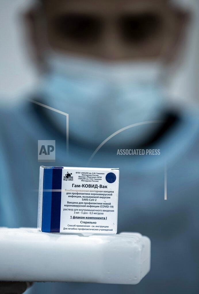 Khalil Hamra A Palestinian medic displays a box of one of 20,000 doses of Russian-made Sputnik V vaccine upon its arrival to Gaza Strip, at the Rafah crossing border with Egypt, Sunday, Feb. 21, 2021. The 20,000 doses of Russia's Sputnik V, donated by the United Arab Emirates and organized by Abbas rival Mohammed Dahlan, entered the Palestinian enclave through its border with Egypt. (AP Photo/Khalil Hamra)