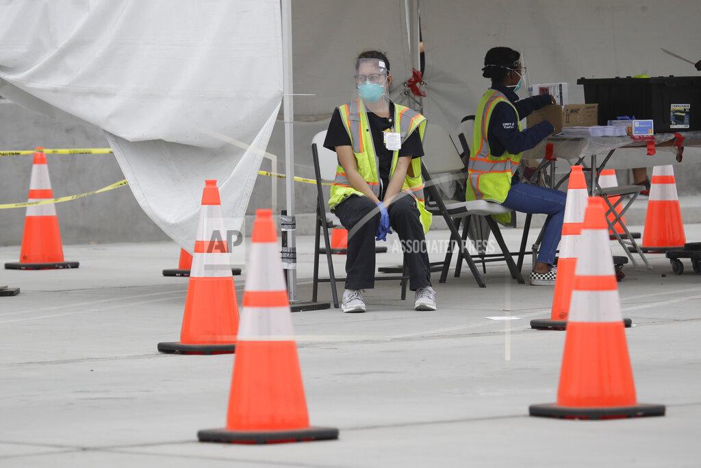 Samples are cataloged at a mobile Coronavirus testing site at the Charles Drew University of Medicine and Science Wednesday, July 22, 2020, in Los Angeles. California's confirmed coronavirus cases have topped 409,000, surpassing New York for most in the nation. (AP Photo/Marcio Jose Sanchez)