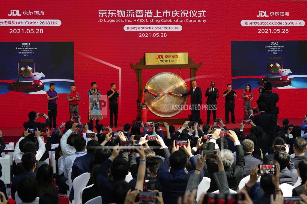 Ng Han Guan Attendees taken part in a ceremony to observe virtually the listing of JD Logistics on the Hong Kong stock exchange from JD.com headquarters in Beijing on Friday, May 28, 2021. JD Logistics' shares jumped 14% in their trading debut Friday in Hong Kong. The company is a subsidiary of Chinese e-commerce giant JD.com. It is the latest technology company to list in the semi-autonomous Chinese city as Beijing intensifies scrutiny of the technology sector. (AP Photo/Ng Han Guan)