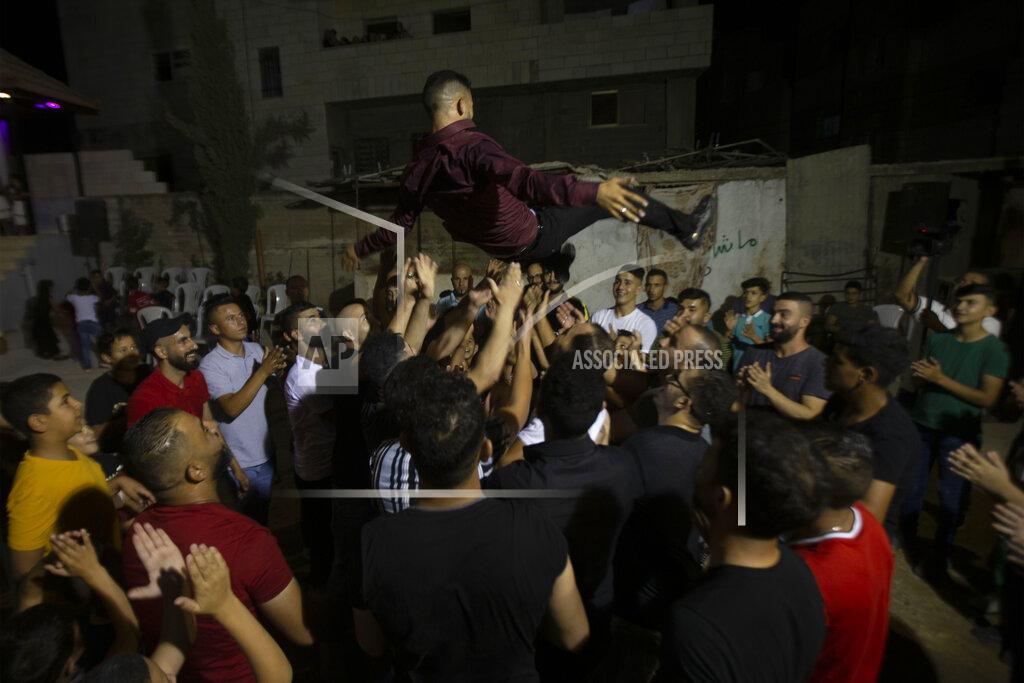 Majdi Mohammed A Palestinian groom is thrown in the air during a wedding party in Azmut near the West Bank city of Nablus, Thursday, Sept. 24, 2020. In a region where marriage is the cornerstone of society, couples are plowing ahead with weddings, despite the deadly risks. From the Palestinian territories to the United Arab Emirates, officials attribute a spike in coronavirus cases to traditional, large-scale weddings that flout public health restrictions. (AP Photo/Majdi Mohammed)