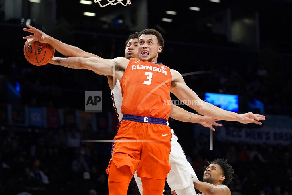 John Minchillo Clemson Tigers' Chase Hunter (3) is fouled on a drive y Virginia Tech's Keve Aluma, behind, in the first half of an NCAA college basketball game during the Atlantic Coast Conference men's tournament, Wednesday, March 9, 2022, in New York. (AP Photo/John Minchillo)