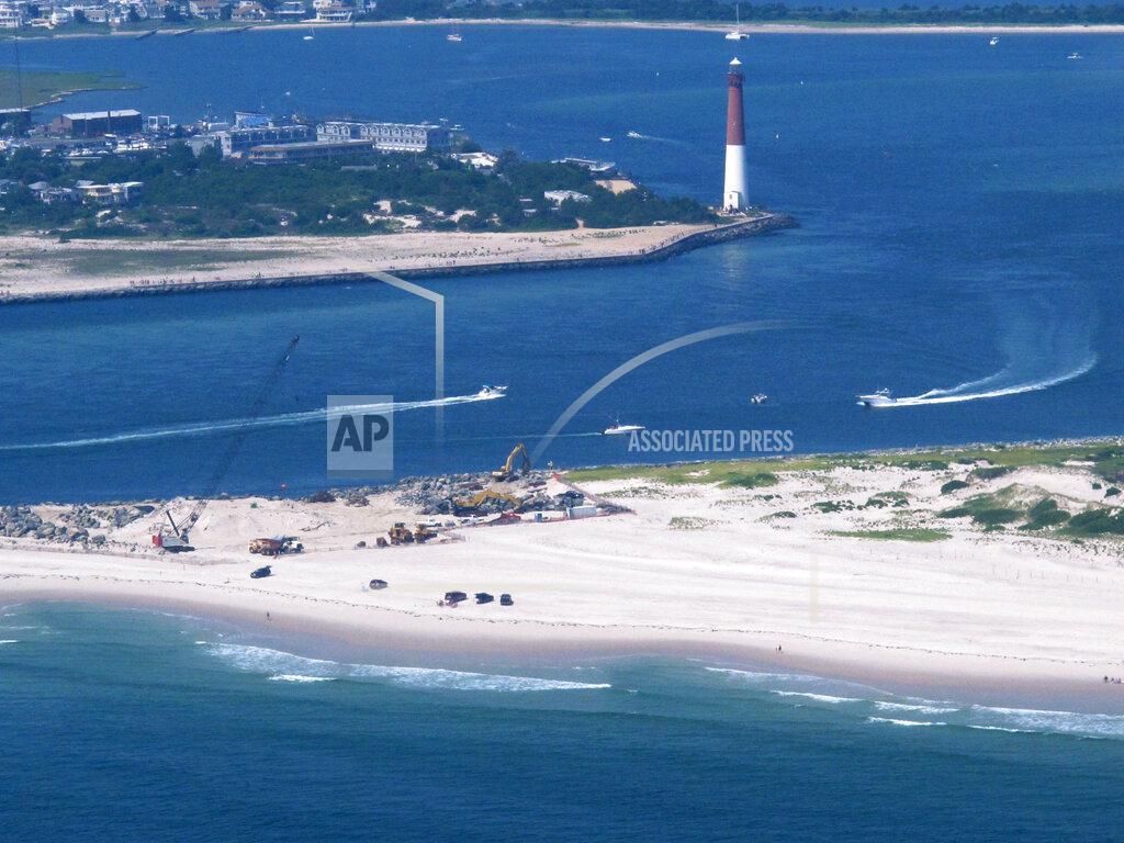 Wayne Parry This July 11, 2014 aerial photo shows the Barnegat Inlet in Barnegat Light, N.J. The inlet is included in a $16 billion flood control plan that would build storm gates that could slam shut across the waterway, a proposal on which the government is seeking public input. (AP Photo/Wayne Parry)