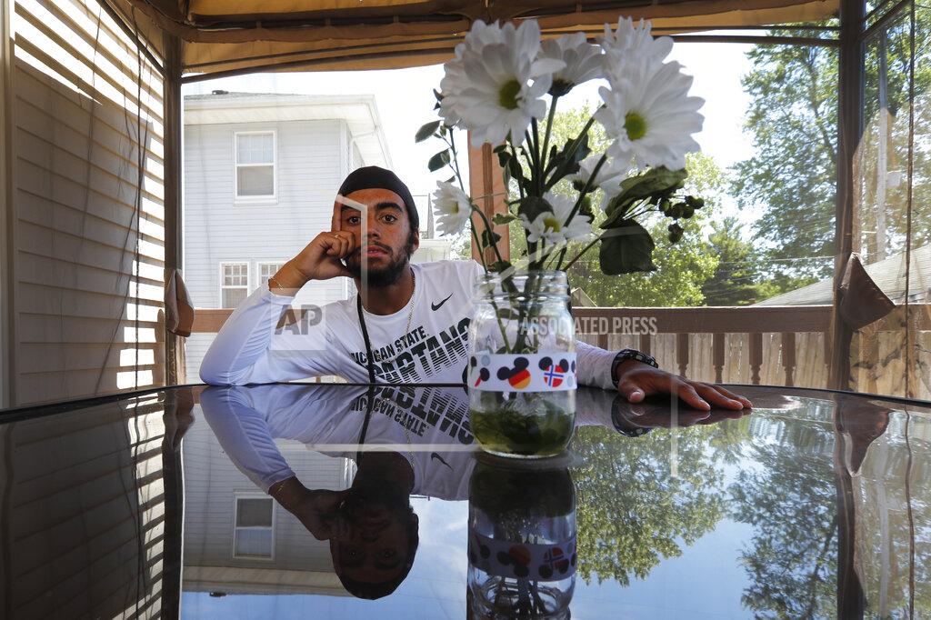 Charles Rex Arbogast Kevin Hayes, a student at Michigan State University, poses for a portrait Monday, June 29, 2020, on his family's back porch in Saginaw, Mich. Hayes, 20, returned home from college after the pandemic effectively shuttered the campus in Lansing. He's spent the time he would have been in school trying to organize, hosting Zoom meetings and calling friends. He said he used to want to be a lawyer, but these days he hopes to run for the state legislature. “I realized I can’t sit on the sidelines,” said Hayes, who is bi-racial. “We have to keep having these tough conversations — organizing people to remember to vote.” (AP Photo/Charles Rex Arbogast)