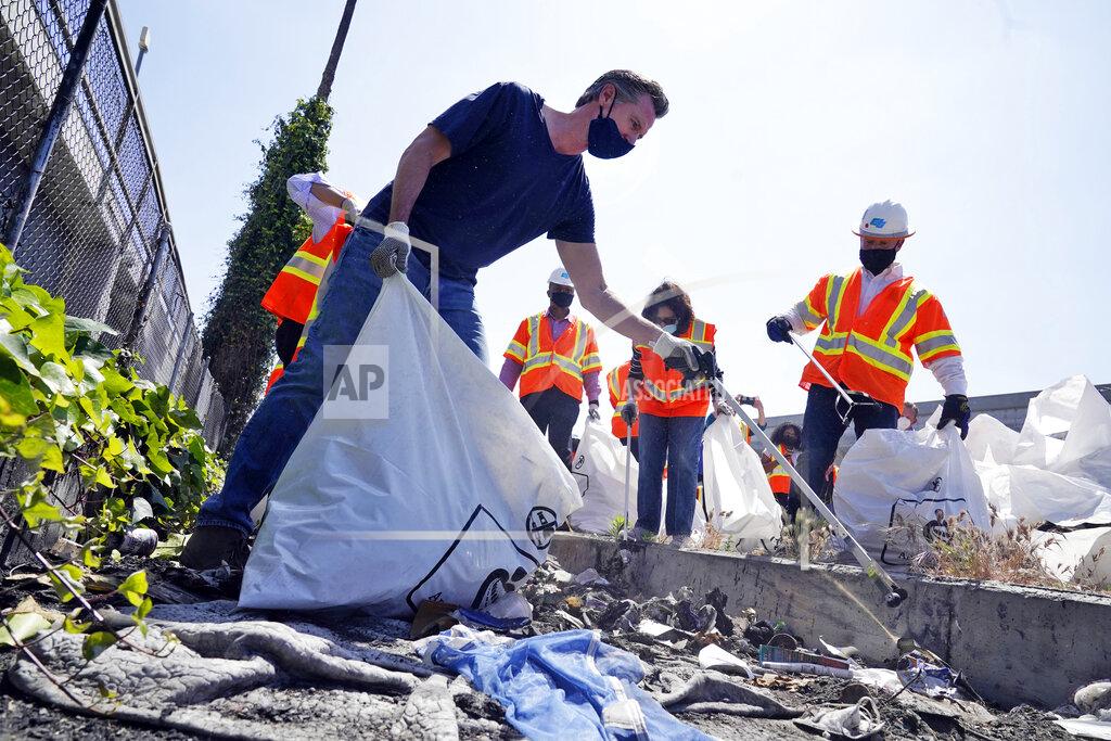 Marcio Jose Sanchez California Gov. Gavin Newsom joins a cleanup effort Tuesday, May 11, 2021, in Los Angeles. Newsom on Tuesday proposed $12 billion in new funding to get more people experiencing homelessness in the state into housing and to "functionally end family homelessness" within five years. (AP Photo/Marcio Jose Sanchez)