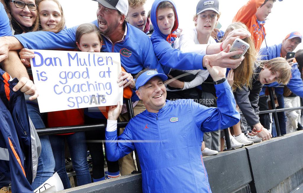 Mark Humphrey Florida head coach Dan Mullen poses for pictures with fans after Florida beat Vanderbilt in an NCAA college football game Saturday, Oct. 13, 2018, in Nashville, Tenn. Florida won 37-27. (AP Photo/Mark Humphrey)
