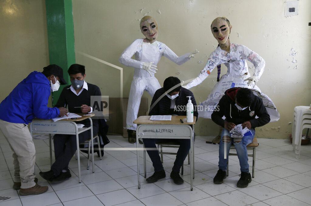Dolores Ochoa A man signs a roster after casting his ballot at a school in Cangahua, Ecuador, Sunday, Feb. 7, 2021. Ecuadoreans went to the polls in first-round presidential legislative elections. (AP Photo/Dolores Ochoa)