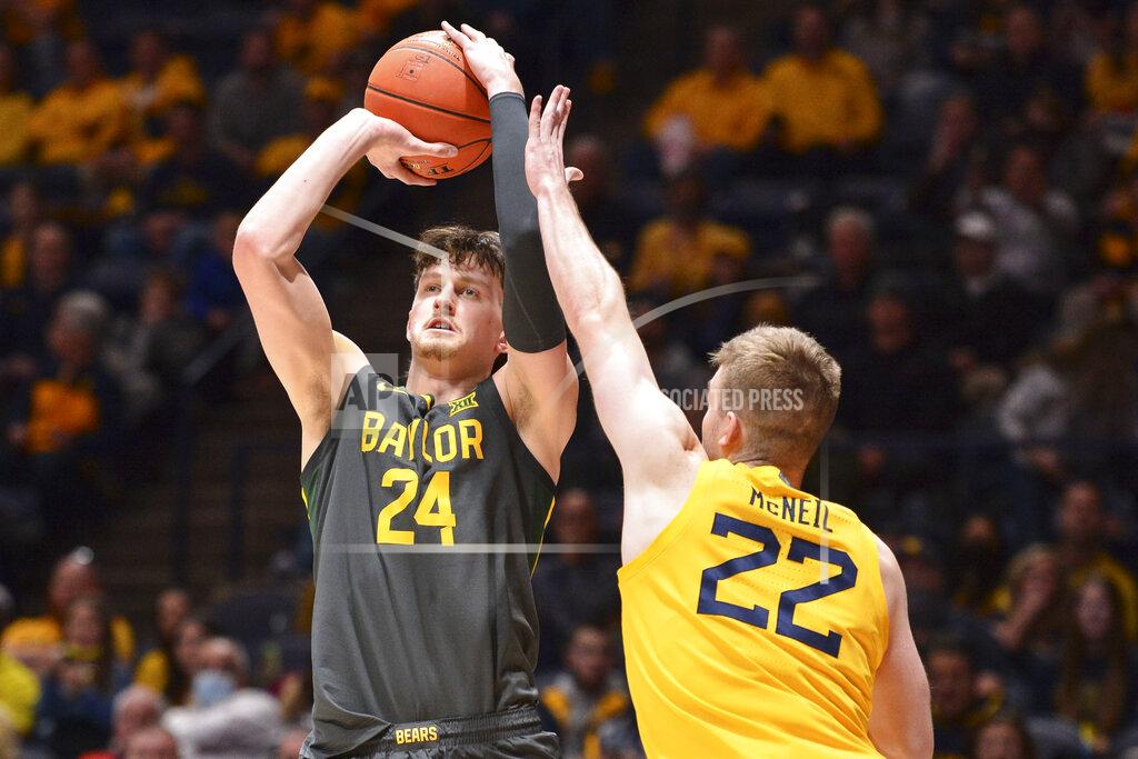 William Wotring Baylor guard Matthew Mayer (24) shoots while being guarded by West Virginia guard Sean McNeil (22) during the second half of an NCAA college basketball game in Morgantown, W.Va., Tuesday, Jan. 18, 2022. (William Wotring)
