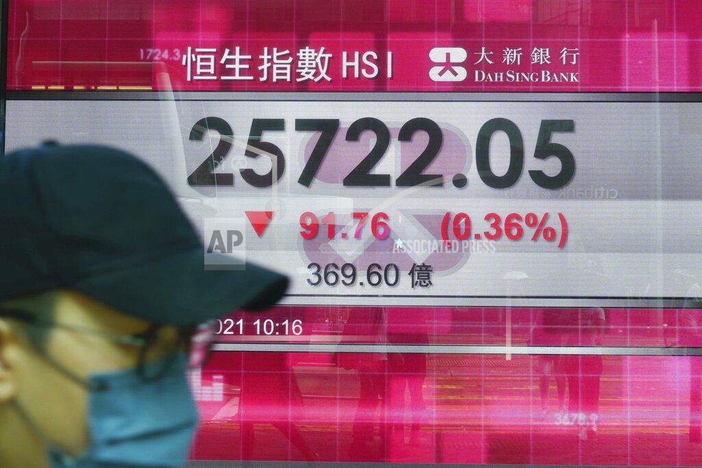 Vincent Yu A man walks past a bank's electronic board showing the Hong Kong share index at Hong Kong Stock Exchange in Hong Kong Tuesday, Sept. 14, 2021. Asian stock markets were mixed Tuesday as investors waited for an update on U.S. inflation that has been stronger than expected. (AP Photo/Vincent Yu)