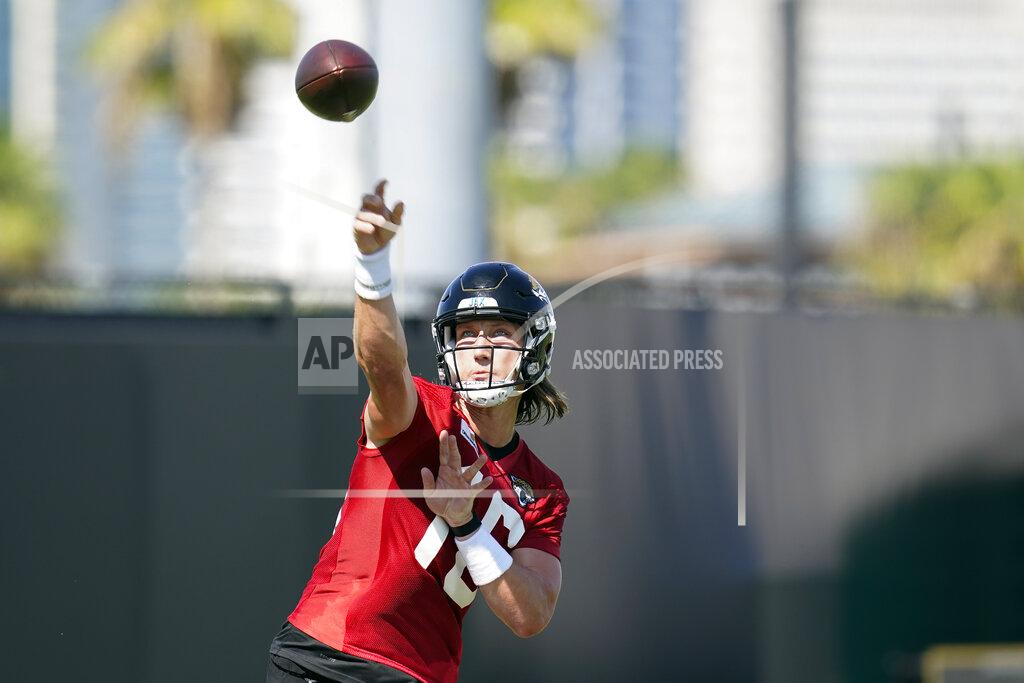 John Raoux Jacksonville Jaguars quarterback Trevor Lawrence throws a pass during NFL football practice, Saturday, July 31, 2021, in Jacksonville, Fla. (AP Photo/John Raoux)
