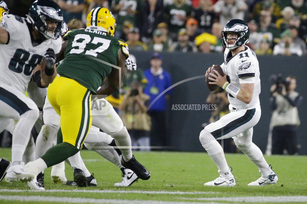 Mike Roemer Philadelphia Eagles quarterback Carson Wentz drops back to pass during the first half of the team's NFL football game against the Green Bay Packers on Thursday, Sept. 26, 2019, in Green Bay, Wis. (AP Photo/Mike Roemer)