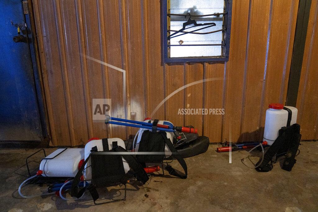 Ore Huiying Spraying equipment lies in a worker's living quarters made of shipping containers in a palm oil plantation run by government-owned Felda in Malaysia, in early 2020. Jum, a former worker who escaped from this same plantation, described to The Associated Press how the company confiscated, described sleeping on the ground, exposed to the wind and monsoon rains, with only a campfire to fend off snakes and tigers. (AP Photo/Ore Huiying)