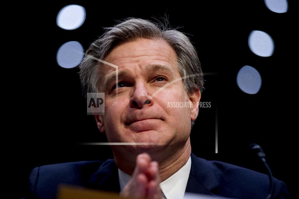 Andrew Harnik FILE - In this Nov. 5, 2019 file photo, FBI Director Christopher Wray pauses while testifying before a Senate Homeland Security Committee hearing on Capitol Hill in Washington. The FBI has found a link between the gunman in a deadly attack at a military base last December and an al-Qaida operative. That's according to a U.S. official who spoke to The Associated Press on Monday. (AP Photo/Andrew Harnik)