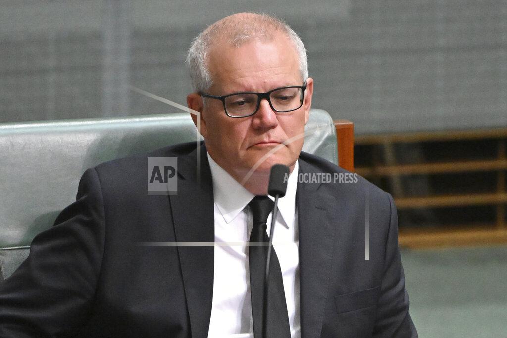 Mick Tsikas Former Prime Minister Scott Morrison listens to a condolence motion in the House of Representatives at Parliament House, in Canberra, Friday, Sept. 23, 2022. Australian lawmakers on Friday paid tribute to Queen Elizabeth II, with some also weighing in on the republic debate, after they returned to parliament from a break taken to observe the queen's death. (Mick Tsikas/AAP Image via AP)