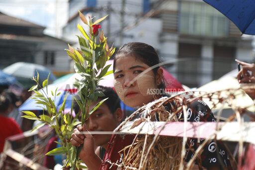 Family members and friends wait to welcome released prisoners outside the Insein Prison Tuesday, Oct. 19, 2021, in Yangon, Myanmar. Myanmar's government on Monday announced an amnesty for thousands of prisoners arrested for taking part in anti-government activities following February's seizure of power by the military. (AP Photo)