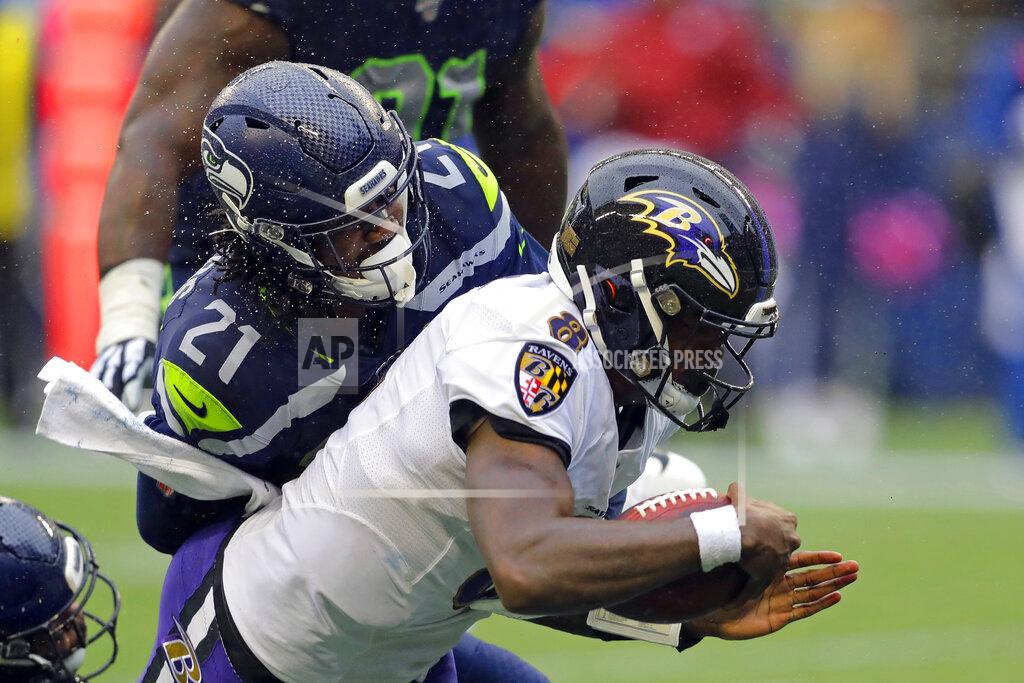 John Froschauer Baltimore Ravens quarterback Lamar Jackson (8) is hit by Seattle Seahawks cornerback Tre Flowers (21) while scoring a touchdown on a fourth-down keeper play during the second half of an NFL football game, Sunday, Oct. 20, 2019, in Seattle. (AP Photo/John Froschauer)