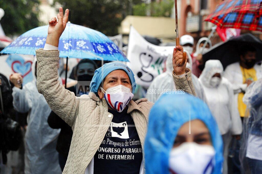 Jorge Saenz Nurses protest to demand government social security for health workers, which includes health care and a pension, the day before International Nurses Day in Asuncion, Paraguay, Tuesday, May 11, 2021. (AP Photo/Jorge Saenz)