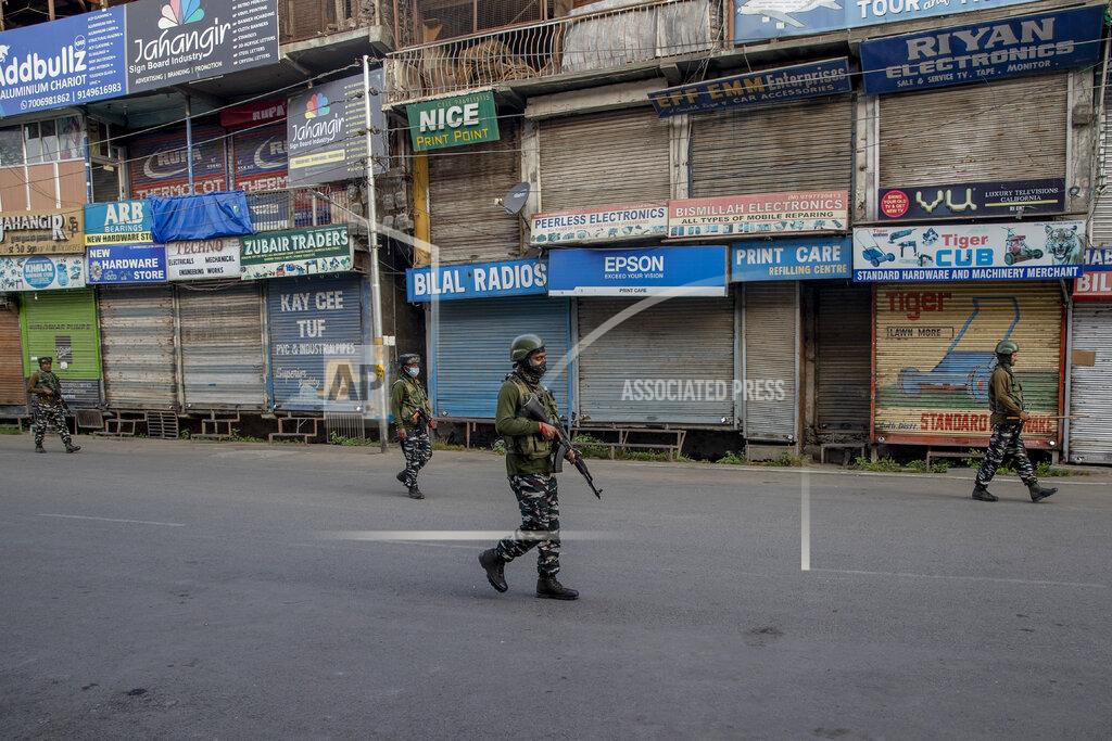 Dar Yasin Indian paramilitary soldiers patrol a deserted street on the first anniversary of India’s decision to revoke the disputed region’s semi-autonomy, in Srinagar, Indian controlled Kashmir, Wednesday, Aug. 5, 2020. Last year on Aug. 5, India’s Hindu-nationalist-led government of Prime Minister Narendra Modi stripped Jammu-Kashmir of its statehood and divided it into two federally governed territories. Late Tuesday, authorities lifted a curfew in Srinagar but said restrictions on public movement, transport and commercial activities would continue because of the coronavirus pandemic. (AP Photo/ Dar Yasin)