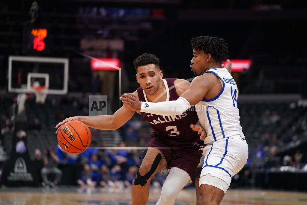 Jeff Roberson Southern Illinois' Dalton Banks (3) dribbles as Drake's Ayo Akinwole (14) defends during the second half of an NCAA college basketball game in the quarterfinal round of the Missouri Valley Conference tournament Friday, March 4, 2022, in St. Louis. (AP Photo/Jeff Roberson)