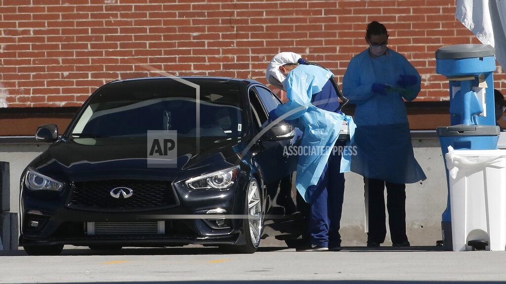 Rick Bowmer Healthcare workers perform COVID-19 Testing at University of Utah's Sugar House Health Center Monday, April 27, 2020, in Salt Lake City. Utah's testing numbers also surpassed 100,000 on Monday, April 27, 2020, with about 4,500 new tests performed. The state is now capable of testing up to 9,000 people daily, but despite the expanded criteria, has been seeing demand under capacity with an average of 4,000 to 6,000 people getting tested daily. (AP Photo/Rick Bowmer)