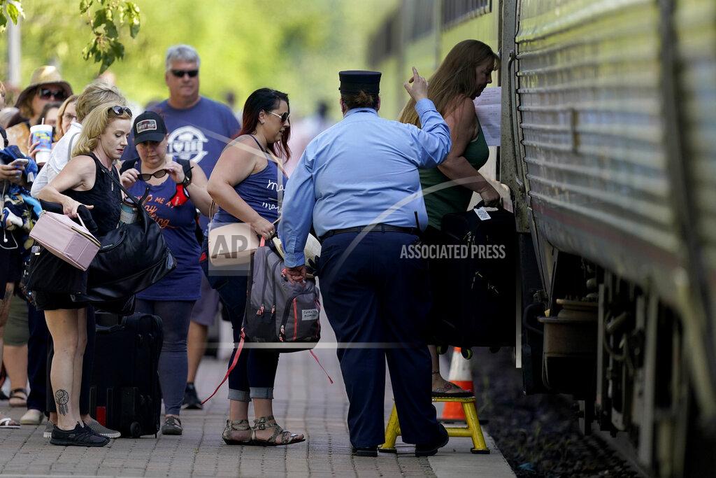Charlie Riedel FILE - In this June 11, 2021, file photo, passengers board a Missouri River Runner Amtrak train in Lee's Summit, Mo. As the U.S. emerges from the COVID-19 crisis, Missouri is becoming a cautionary tale for the rest of the country: It is seeing an alarming rise in cases because of a combination of the fast-spreading delta variant and stubborn resistance among many people to getting vaccinated. (AP Photo/Charlie Riedel, File)