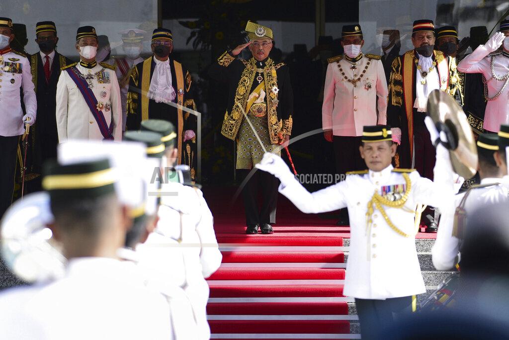 Shaiful Nizal Ismail In this photo released by Malaysia's Department of Information, Malaysia's King Sultan Abdullah Sultan Ahmad Shah, center, salutes during the opening ceremony of the third term of the 14th parliamentary session at parliament house in Kuala Lumpur Monday, May 18, 2020. Malaysia's parliament held an unusual half-day sitting Monday, that was kept short due to the COVID-19 pandemic and saw Prime Minister Muhyiddin Yassin dodge a vote of no-confidence against him over two months since he came into power. (Shaiful Nizal Ismail/Malaysia's Department of Information via AP)