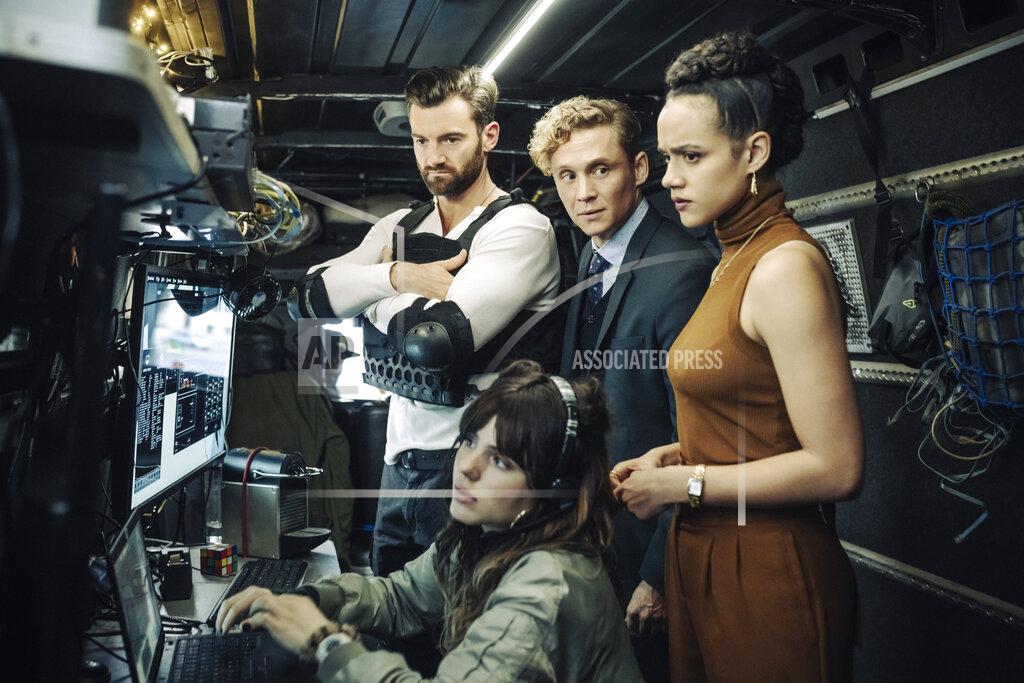 Stanislav Honzik This image released by Netflix shows, clockwise from top left, Stuart Martin, Matthias Schweighöfer, Nathalie Emmanuel and Ruby O. Fee in "Army of Thieves." (Stanislav Honzik/Netflix via AP)