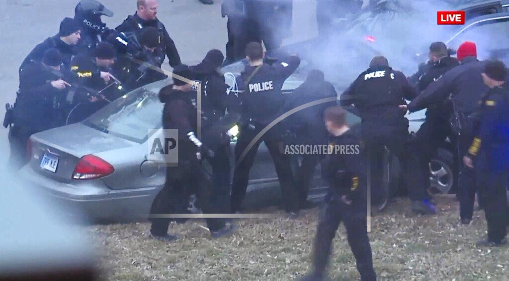 Uncredited In this image take from video, law enforcement personnel surround a car after it was stopped as the driver approached the crowd near Union Station attending the Super Bowl parade and rally for the Kansas City Chief in Kansas City, Mo., Wednesday, Feb. 5, 2020. (FOXKC via AP)
