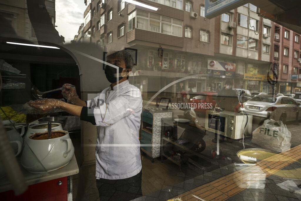Emrah Gurel Mahmut Husyar, a member of the Uighur community living in Turkey, works in his restaurant, in Istanbul, Tuesday, Feb. 2, 2021. Because of shared cultural ties, Turkey has long been a safe haven for the Uighurs, a Turkic group native to China's far west Xinjiang region. Opposition legislators in Turkey are accusing Ankara's leaders of secretly selling out Uighurs to China in exchange for coronavirus vaccines.(AP Photo/Emrah Gurel)