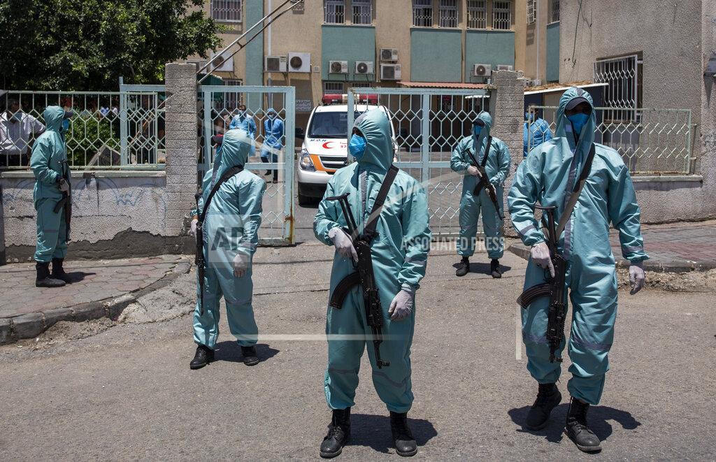 Khalil Hamra Palestinian Hamas police officers wear protective suits as they take part in a simulation of possible coronavirus infections in Gaza City, Saturday, July 18, 2020. (AP Photo/Khalil Hamra)