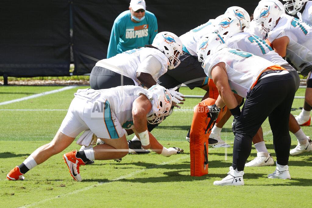 Joel Auerbach From left, Miami Dolphins center Ted Karras (67) and defensive tackle Durval Queiroz Neto (69) run a drill during NFL football practice in Davie, Fla., Friday, Sept. 11, 2020. (AP Photo/Joel Auerbach)