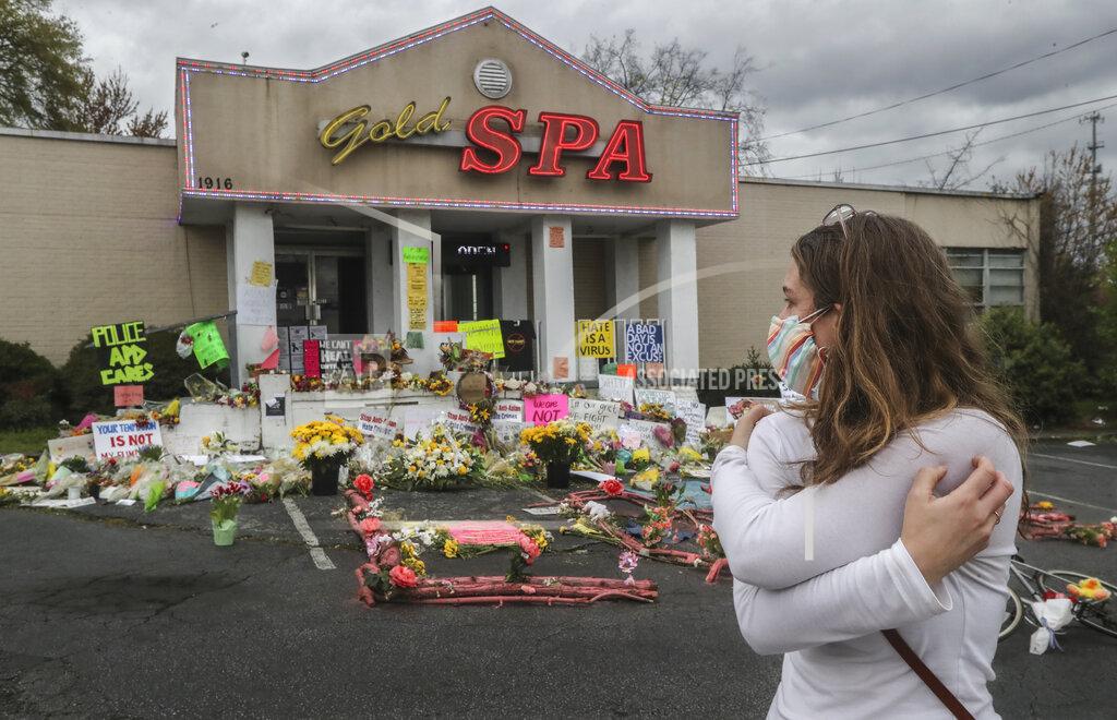 John Spink Hollis Wright collects her thoughts as she becomes emotional in front of the Gold Spa, where multiple people were killed in last week's shooting, in Atlanta., Wednesday March 24, 2021. (John Spink/Atlanta Journal-Constitution via AP)