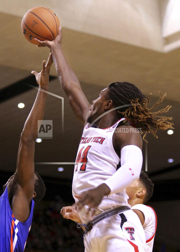 Ben Powell Texas Tech's Christ Clarke scores over Houston Baptist defender Benjamin Uloko, left, during an NCAA college basketball game Wednesday, Nov. 13, 2019, in Midland, Texas. (Ben Powell/Odessa American via AP)