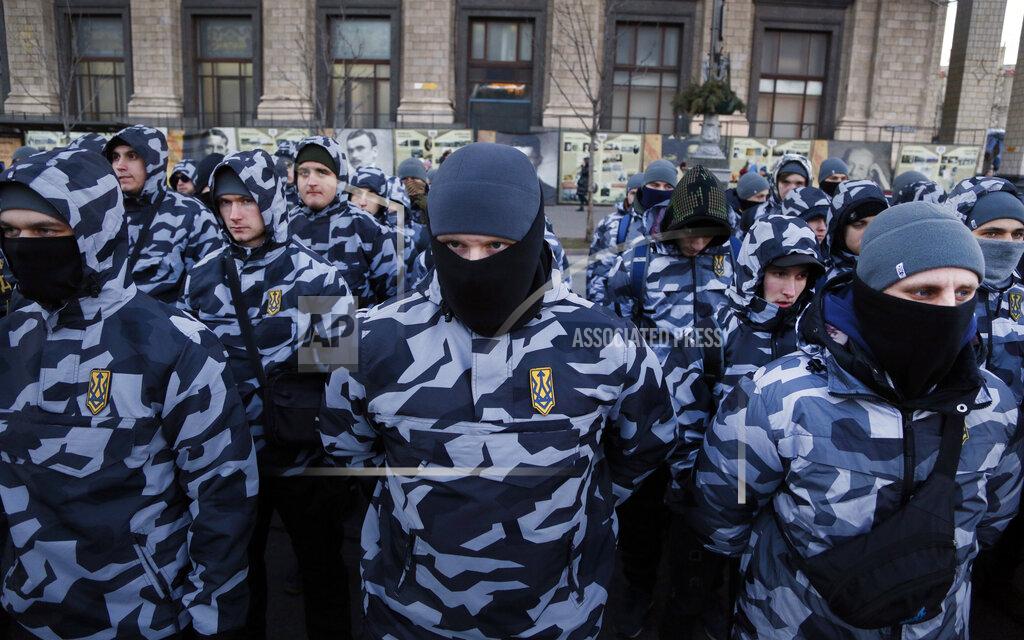 Efrem Lukatsky FILE - Volunteers with the right-wing paramilitary Azov National Corps stand to attention less than a month before the country's presidential vole during a march along the main street in Kiev, Ukraine, on March 2, 2019. The Ukrainian forces who made a determined last stand in a Mariupol steel mill against Russian troops were a mixture of seasoned soldiers, border guards, a controversial national guard regiment and volunteers who took up arms in the weeks before Russia's invasion. (AP Photo/Efrem Lukatsky, File)