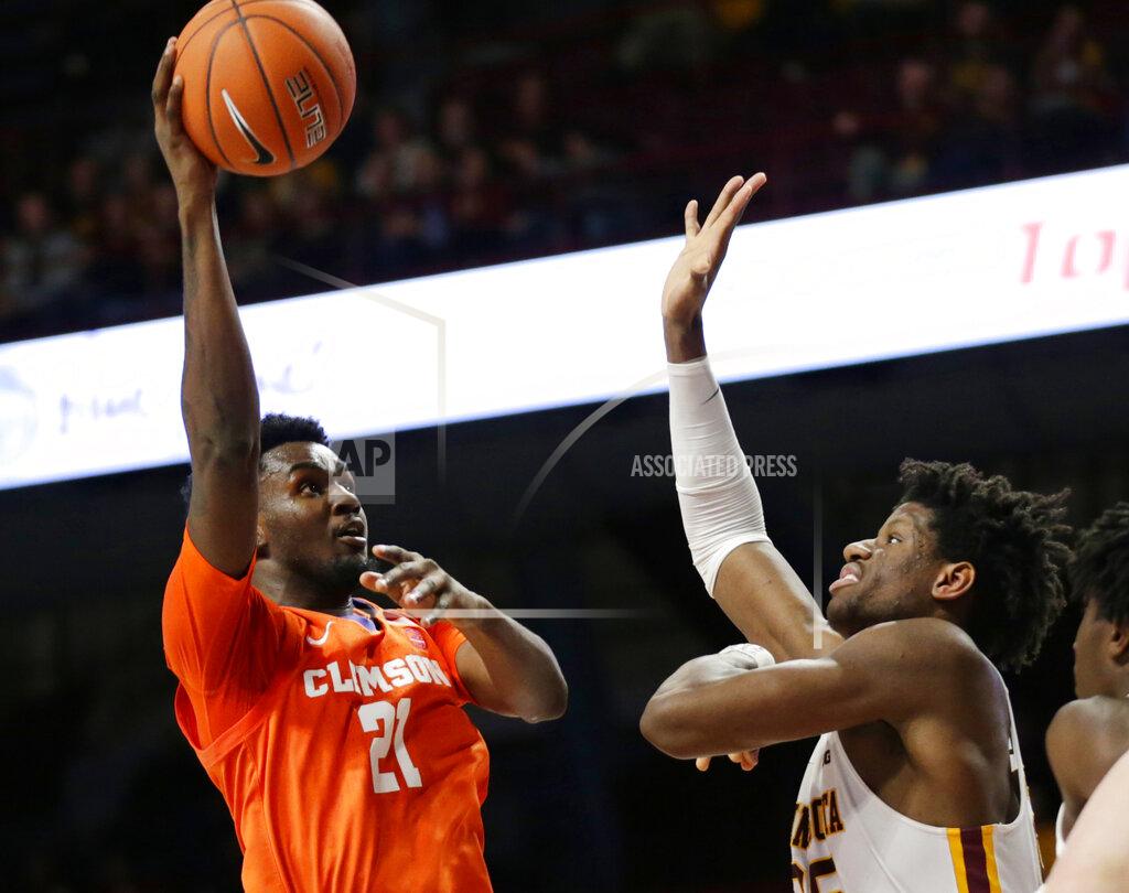 Andy Clayton-King Clemson forward Khavon Moore (2) shoots against Minnesota center Daniel Orturu in the second half during an NCAA college basketball game Monday, Dec. 2, 2019, in Minneapolis. (AP Photo/Andy Clayton-King)